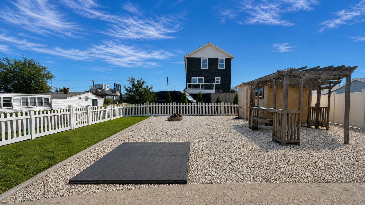 Fenced backyard with pergola